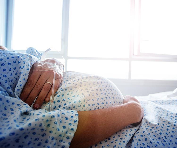 Doctor checking on pregnant mom in the delivery room