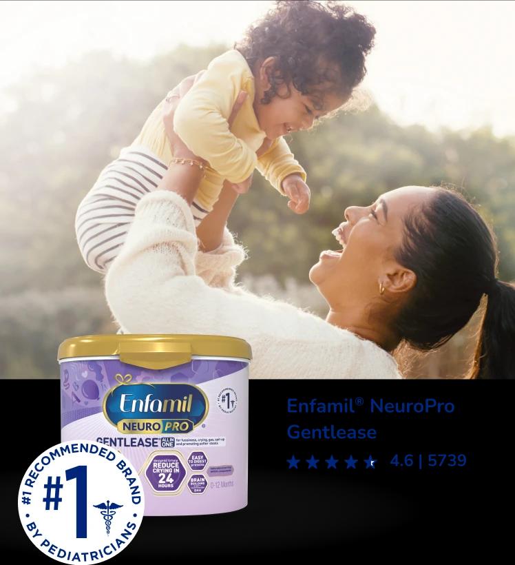 Parent joyfully lifting baby in sunlit outdoor setting