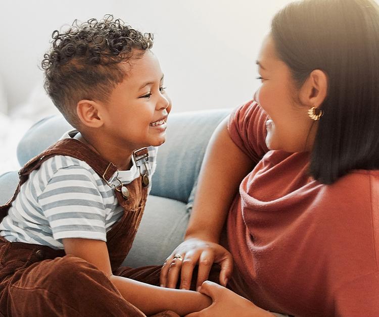 Mom and son sitting on floor talking to each other